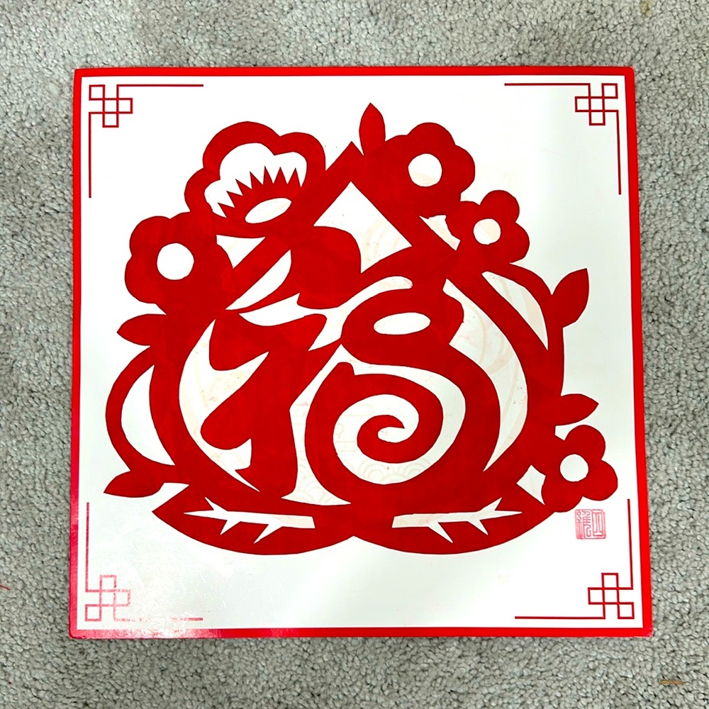 Traditional Chinese handmade paper-cutting artworks bear the artist's seal.